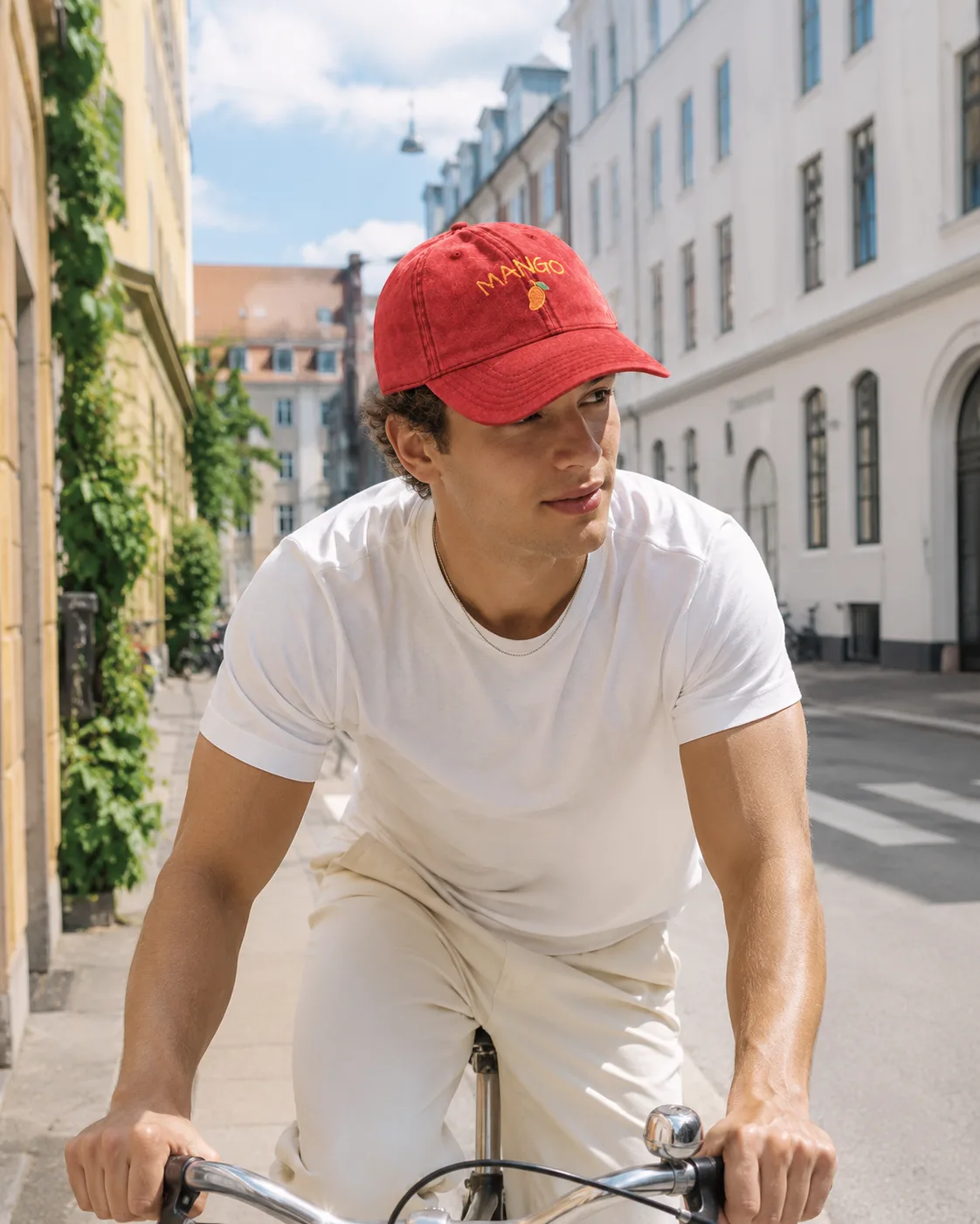 Man wearing the red Mango cap while cycling