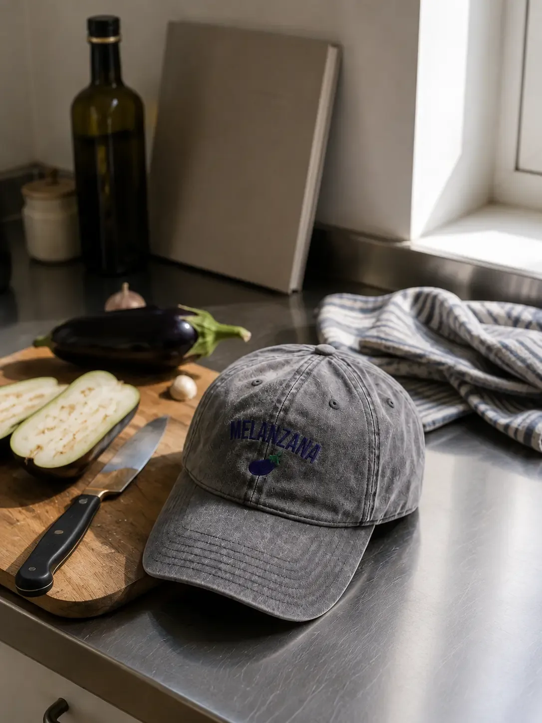 Melanzana cap in a kitchen still life with aubergines